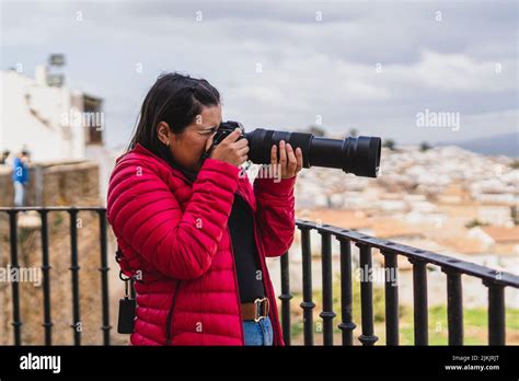 A Young Female Taking Photos Of A View With A Professional Camera Stock