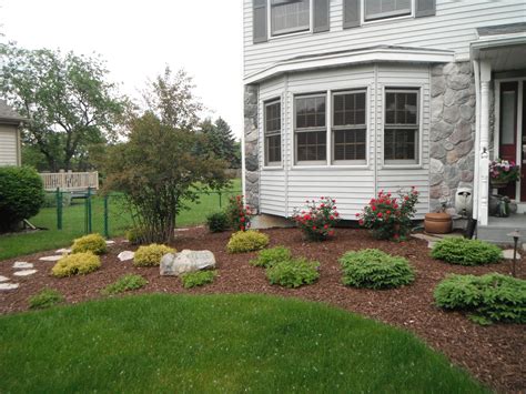 Combination Of Evergreens Perennials And Flowering Shrubs Front
