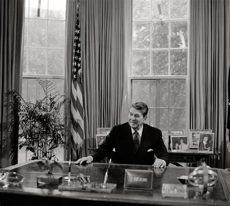 President Ronald Reagan At His Desk In The White House Oval Office