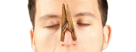 Man With Clothespin On Nose Isolated On White Backgroud Stock Photo