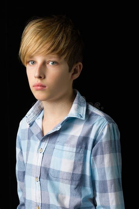 Closeup Portrait Of Handsome Blond Boy Studio Photo On A Black