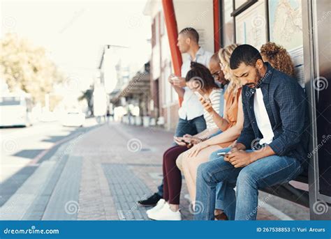 The Wait Feels Quicker When You Stay Occupied A Group Of People Using Their Cellphones While