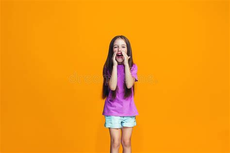 Isolated On Orange Young Casual Teen Girl Shouting At Studio Stock