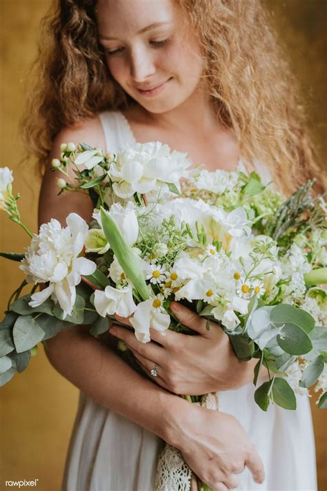 Download Premium Image Of Woman Holding A Bouquet Of White Flowers