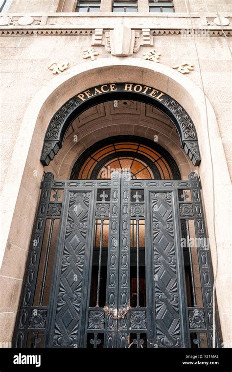 Exterior Entrance Of Peace Hotel With Ornate Metal Door Shanghai