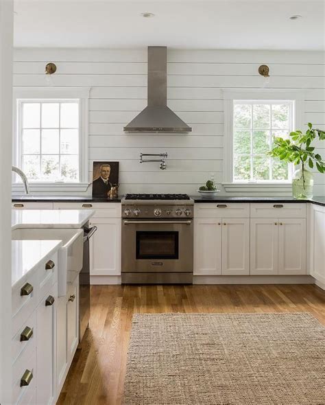Time is flying, and things are moving along nicely with our kitchen remodel! Shiplap walls, white cabinetry, honed absolute black granite, antique brass cup pulls | MMID ...