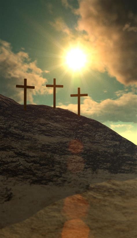 Three Crosses Sitting On Top Of A Hill With The Sun Shining Behind Them