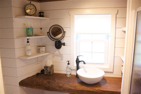 In the interest of maximizing storage space, many tiny house bathrooms opt for shelving over the vanity instead of a mirror. Tiny house bathroom vanity. reclaimed barn wood with ...