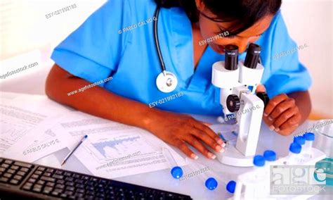 Pretty Nurse Working At Laboratory In Blue Uniform Stock Photo