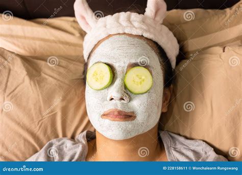 Face Focusing Of Young Beautiful Asian Woman Is Doing Facial Mask With