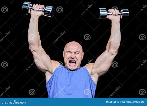 Muscular Man With Arms Raised Lifting Dumbbells Stock Image Image Of