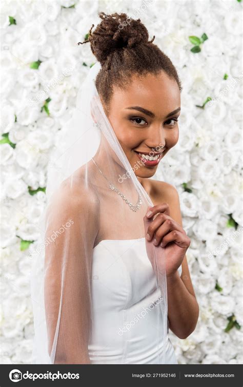 Happy African American Bride Touching White Veil Flowers Stock Photo By