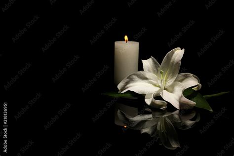 Beautiful Lily And Burning Candle On Dark Background With Space For