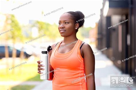 African American Woman Drinking Water From Bottle Stock Photo Picture
