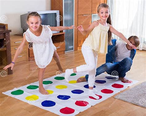 Children Playing Twister At Home Stock Photo Image Of Male Children