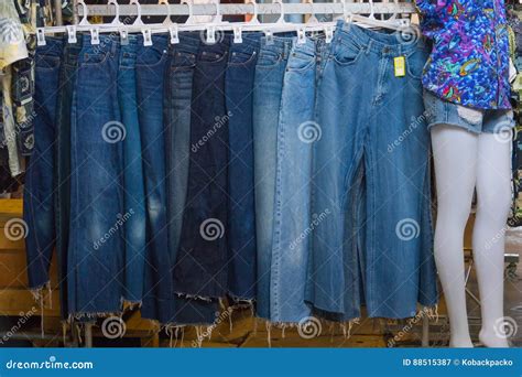 A Rack Of A Variety Of Blue Denim Jeans In Various Shades Of Blu Stock