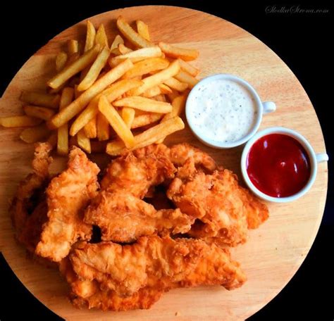 Fried Chicken French Fries And Ketchup On A Plate With Dipping Sauces