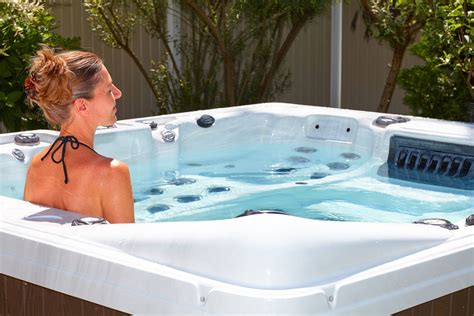 beautiful woman relaxing in hot tub rising sun pools and spas