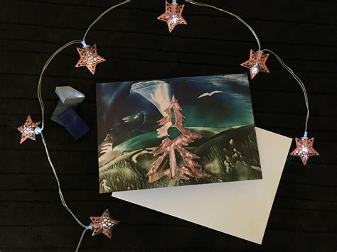 A Greeting Card With An Image Of A Tree Surrounded By Stars