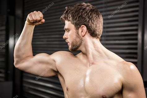 Shirtless Man Flexing Biceps Stock Photo By ©wavebreakmedia 100422086