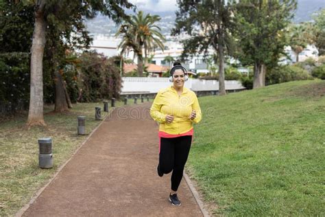 Curvy Woman Jogging Outdoor At City Park Focus On Face Stock Image