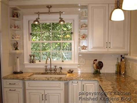 Typhoon bordeaux granite with canvas color off white cabinets, travertine subway backsplash, natural stone slate hood. Finished Kitchens Blog: 05/04/09
