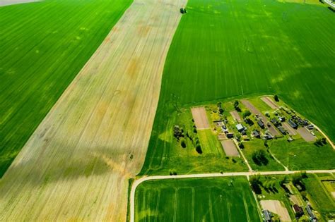 Premium Photo Top View Of A Sown Green Field And A Small Village In