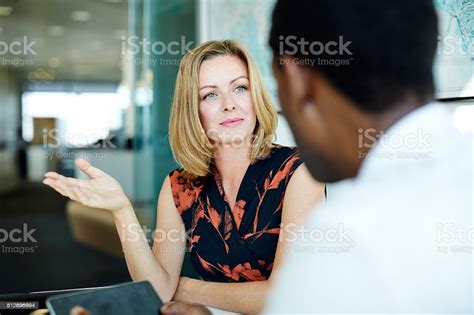 Exchanging Ideas In The Office Stock Photo Download Image Now