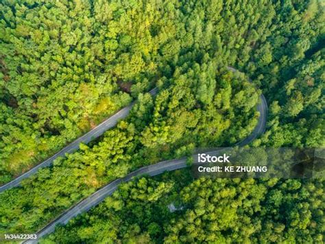 Aerial Photography Of Winding Mountain Road And Green Forest Stock