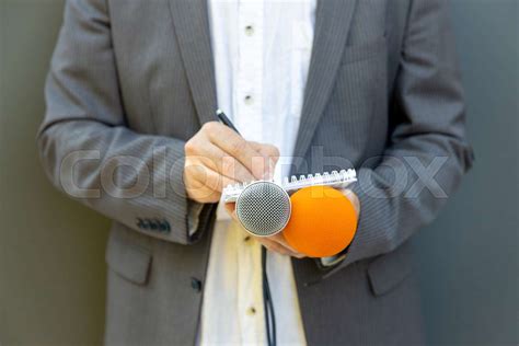 Male Journalist At News Conference Or Media Event Holding Microphone