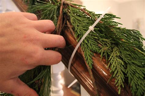 Christmas garlands are beautiful festive decorations for homes. How To Hang Garland On Your Banister - Summer Adams
