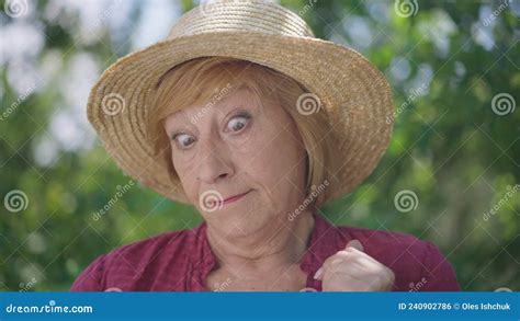 Front View Thoughtful Embarrassed Caucasian Senior Woman Solving Crossword Puzzle In Slow Motion