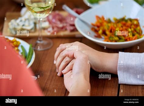 Hands Of People At Table Praying Before Meal Stock Photo Alamy