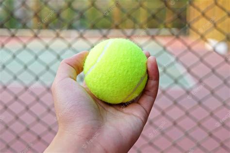 Premium Photo Hand Holding Tennis Ball