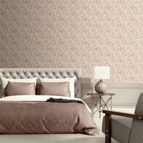 A Large Bed Sitting Next To A Chair In A Bedroom Under A Wallpapered