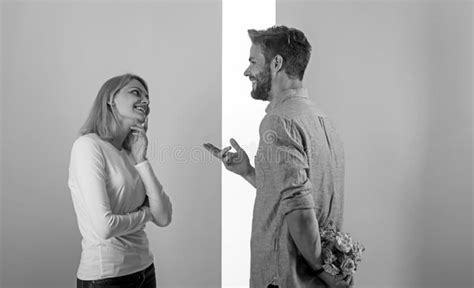 Clever Attentive Guy Making Surprise For Holiday Man With Beard Holds Bouquet Behind Back