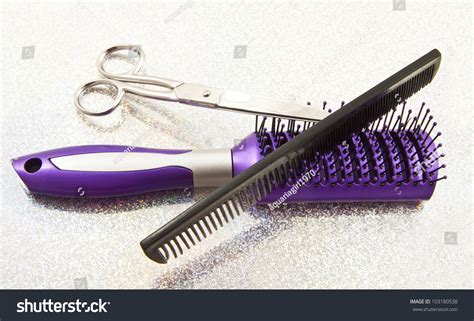 Purple Brush Comb And Scissors On A Glittering Background Stock Photo