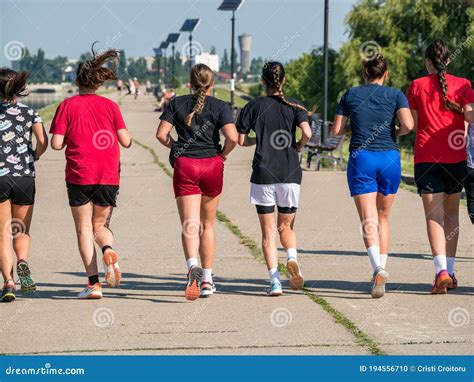 Sport Girls Team Training Or Running Girls Jogging In A A Park