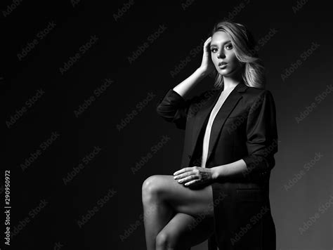 Sensual Young Blonde Woman Sitting On The Chair With Her Legs Crossed