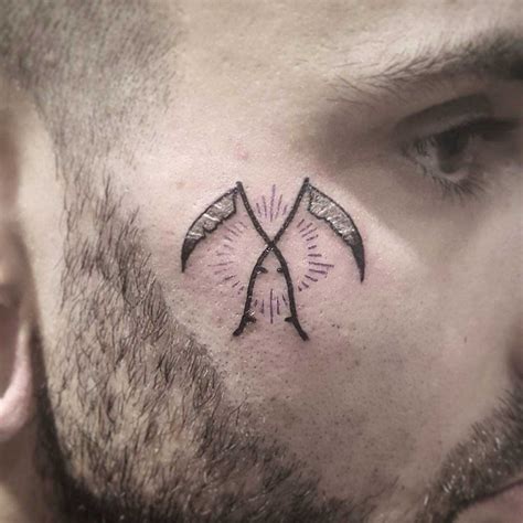 Crossed Scythes Tattoo On Face Best Tattoo Ideas Gallery