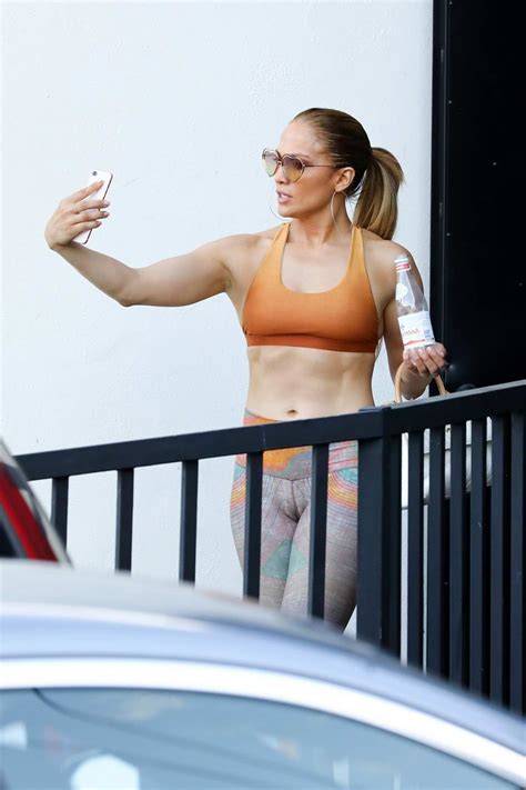 Jennifer Lopez Shows Off Her Toned Abs In An Orange Sports Bra And Print Leggings As She Leaves