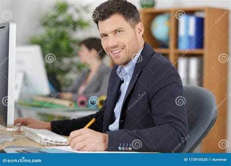 Male Office Worker Sitting At Desk Stock Photo Image Of Sitting