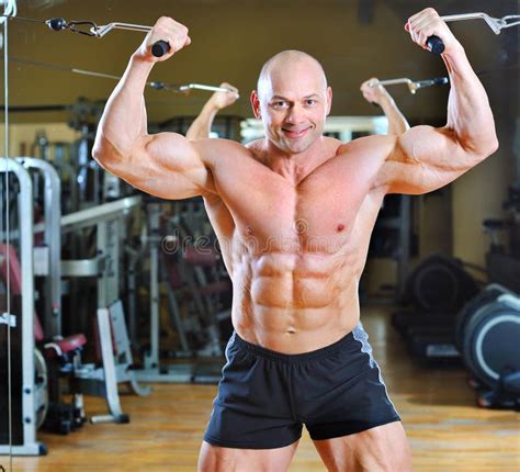 Strong Man Bodybuilder In Gym Corporate Pose With Naked Torso Stock