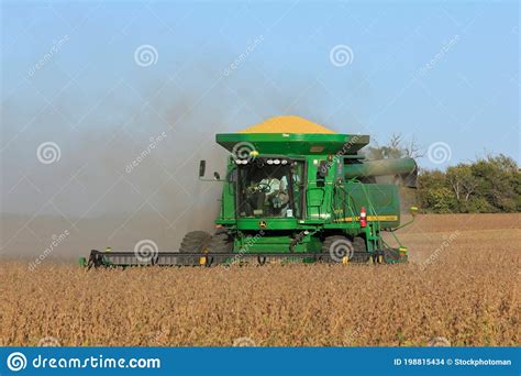 John Deere Combine Cutting Soybeans In A Farm Field In The Fall With