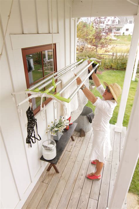 Ceiling mounted electric clothes drying stand. Carol, Owner of The New Clothesline Company Hanging some ...