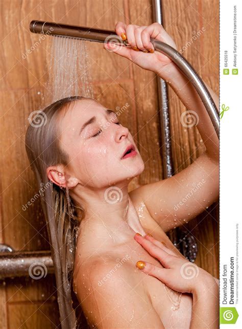 Beautiful Woman Standing At The Shower She Holds In Her Hand Showerhead Stock Photo Image Of
