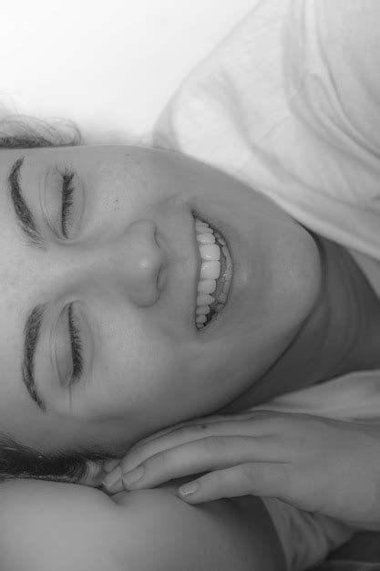 Premium Photo Close Up Of Smiling Girl Lying Down At Home