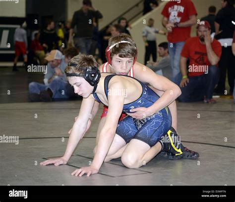 Teen Boys On The Mat Ready To Resume Action During A Wrestling Match