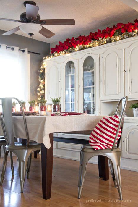 The cabinet would've appeared huge and the things on top would have looked crowded. 34 Ways to Decorate Your Home with Garland | Christmas Designers