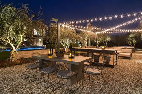 Using a painted hula hoop, a few strings of icicle lights and black electrical tape, you can have a magnificent lighting piece for your backyard. 20 Amazing Backyard String Light Ideas For A Dreamy Ambiance